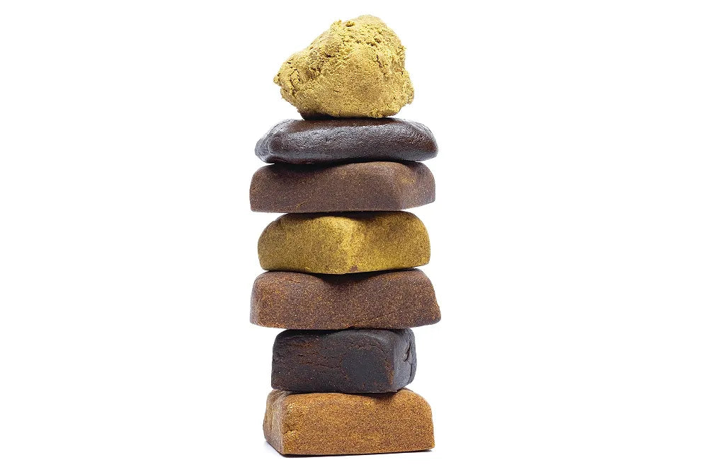 A stack of differently colored and textured pieces of hash.
