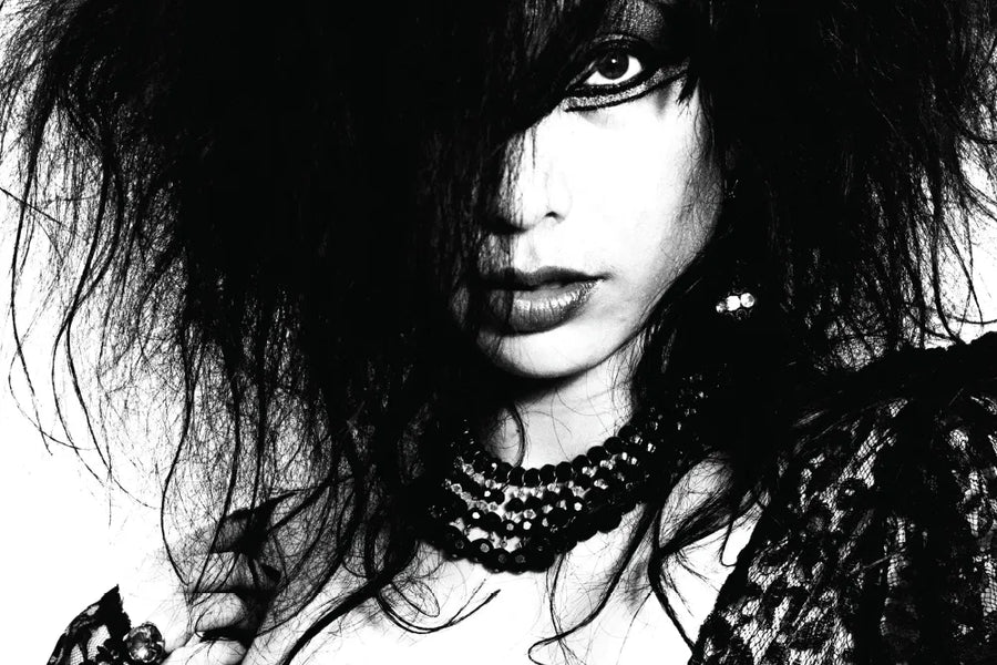 Story artwork: A tightly cropped black-and-white portrait of Exene of X.