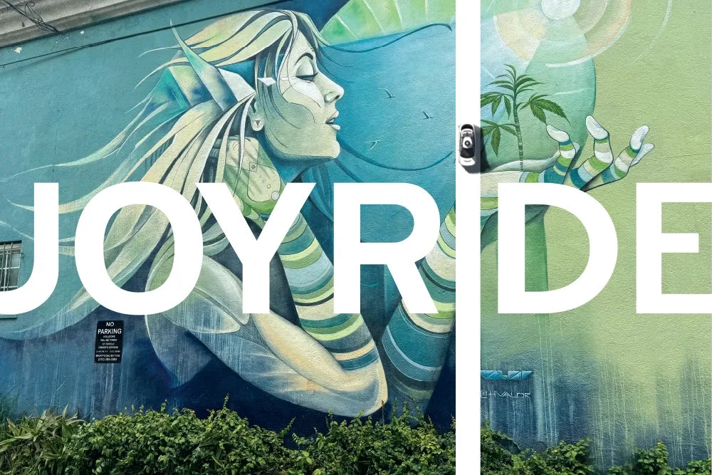 A green goddess mural with the word “Joyride” across it.