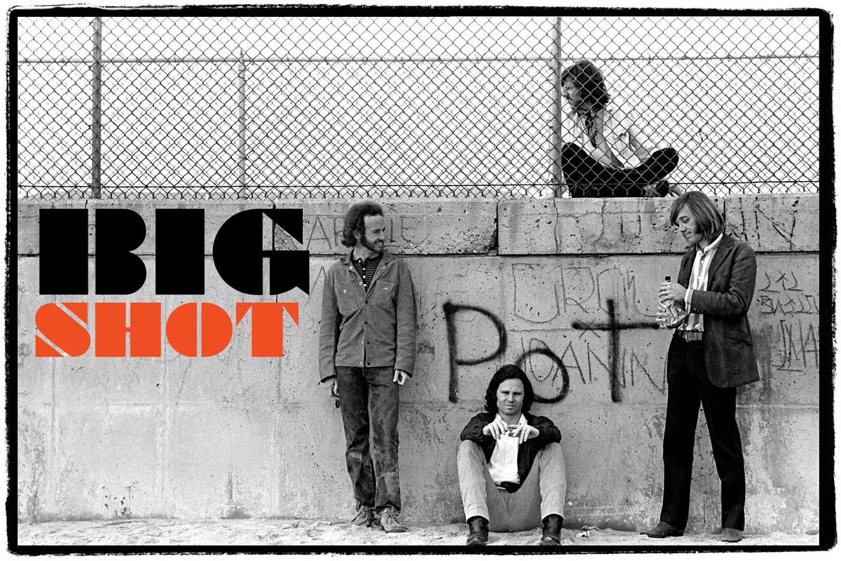 A black-and-white band portrait against a chain-link fence with the words “Big Shot.”