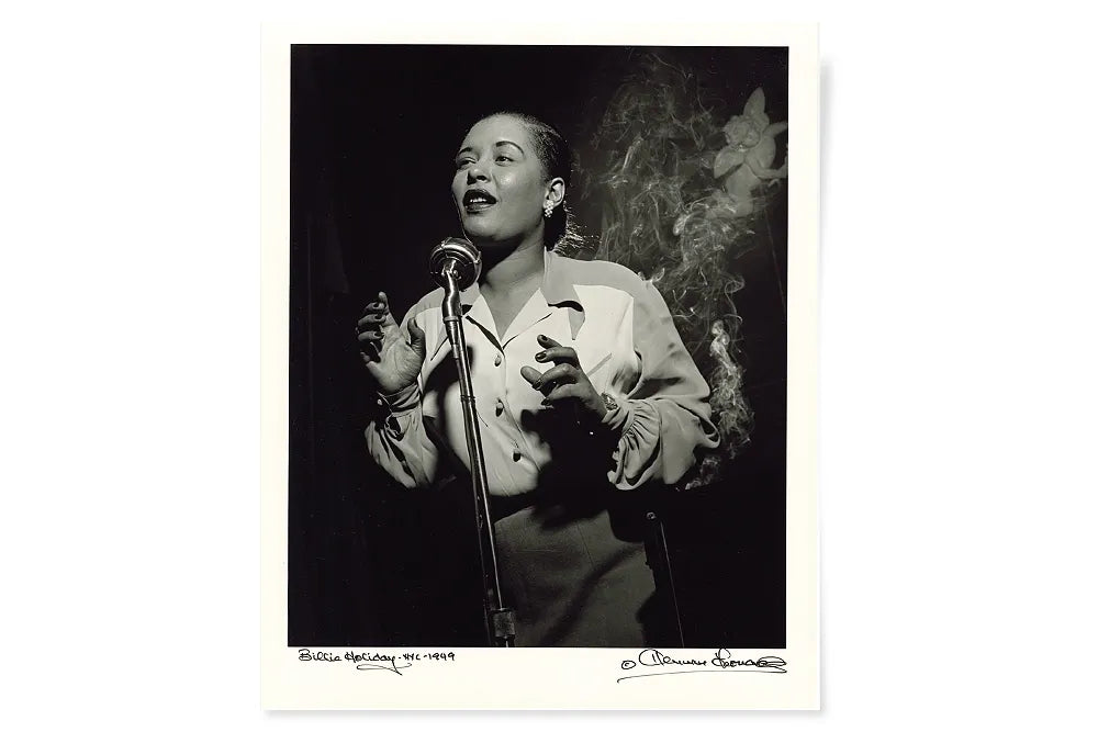 A black-and-white portrait of a singer performing at a microphone.