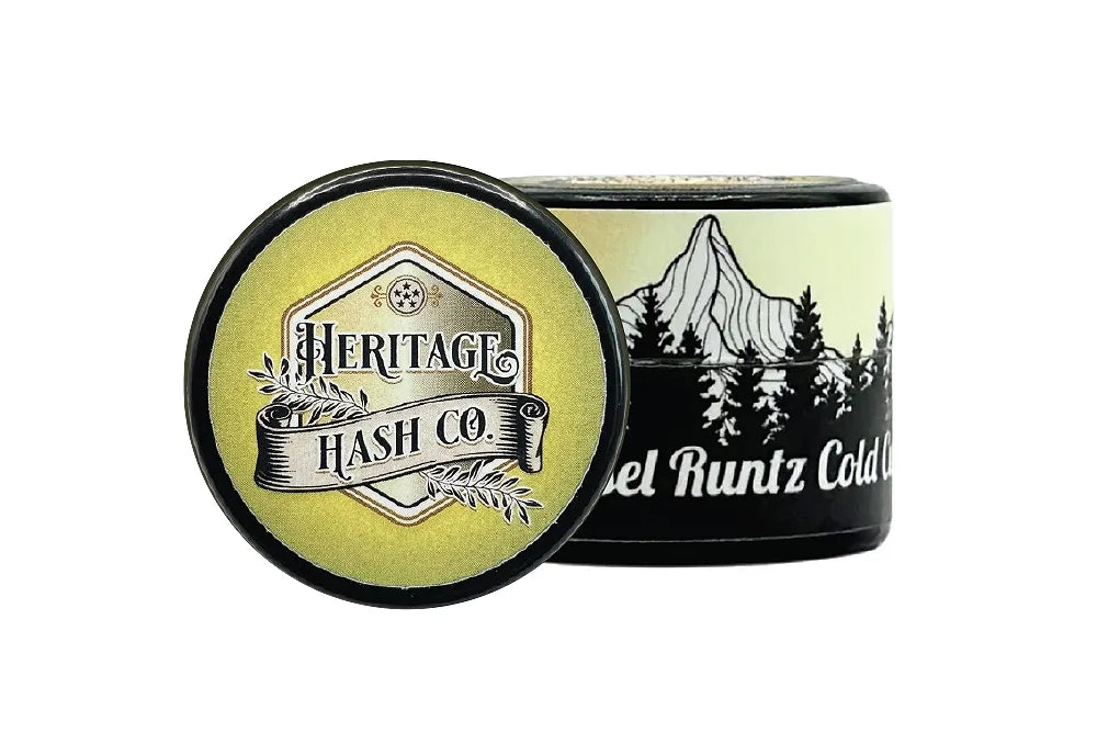 A Heritage Hash Co. jar and lid with forest artwork.
