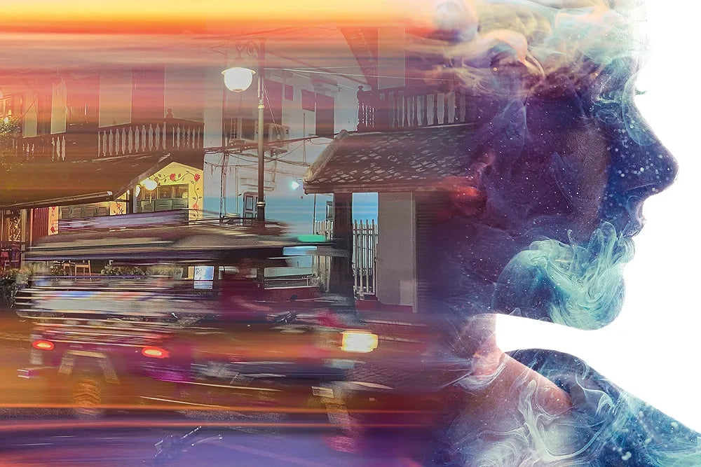 A layered collage of a woman's profile, street scenery and colorful smoke.