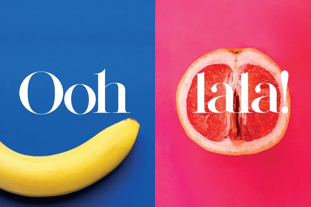 “Ooh lala!” lettering over a banana and halved grapefruit on blue and pink.