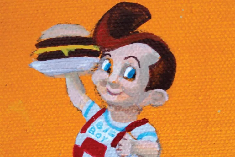 A close crop of the painted Big Boy mascot holding a burger.