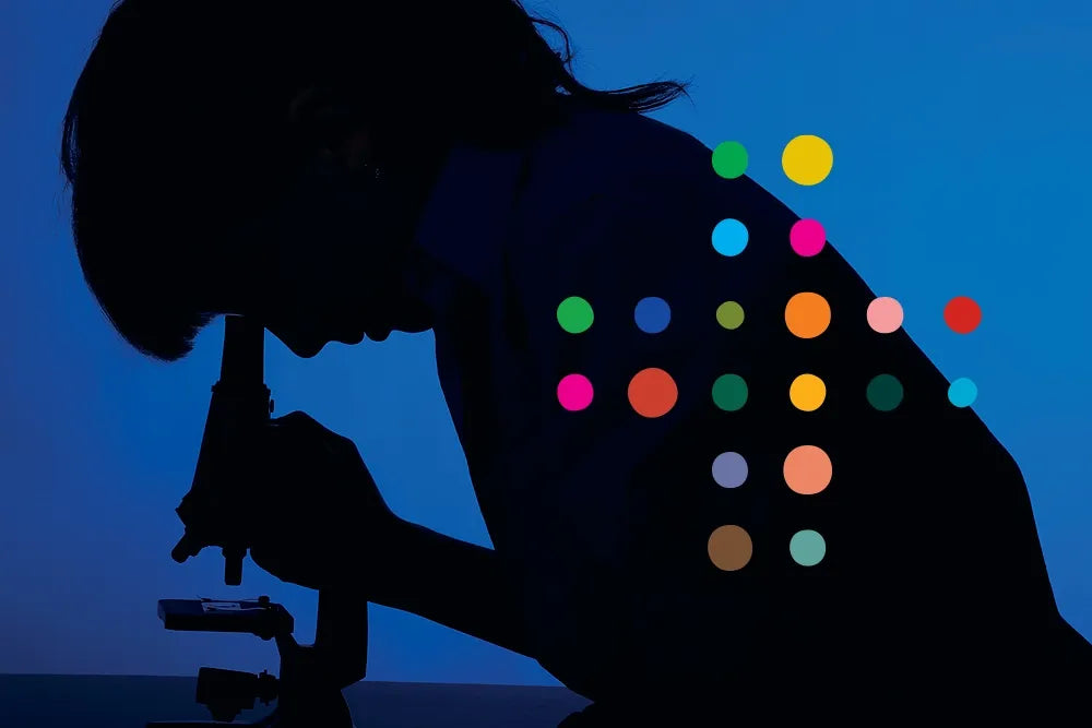A scientist's silhouette at a microscope, overlaid with colorful circles.