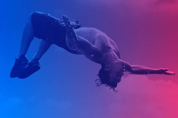 A swimmer arches backward underwater in blue and pink light.