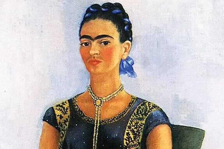 A close crop of Frida Kahlo's painted portrait with a necklace and braided hair.