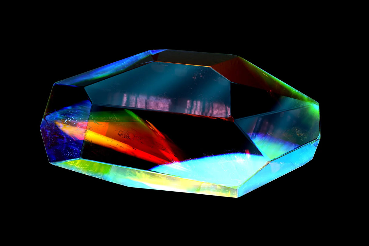 A faceted crystal refracts rainbow colors against black.