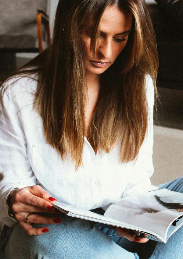 A reader looks through an open magazine.